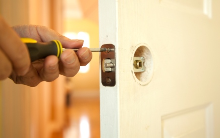 Handyman in Readville, MA fixing door.